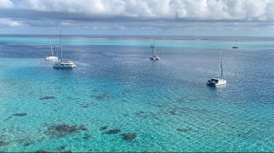 a blue and white boat floating on a body of water