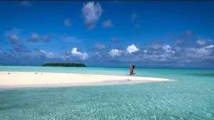 a sandy beach next to the ocean