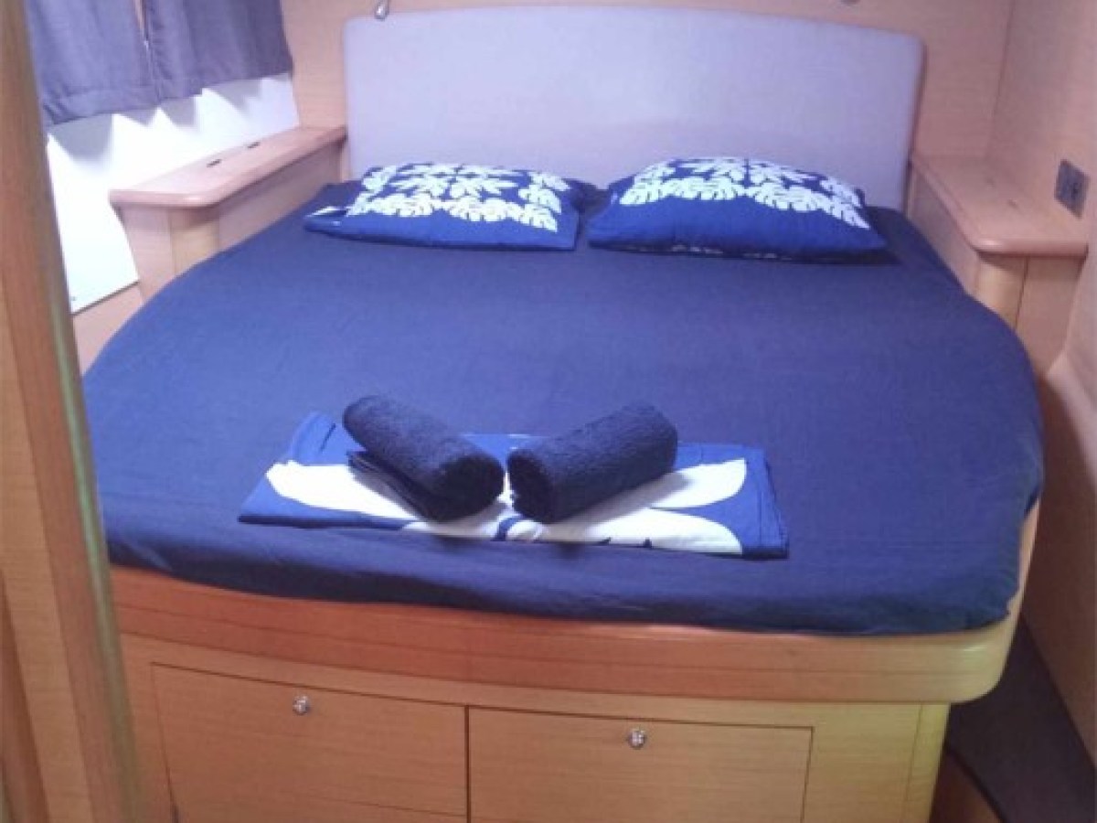 a bedroom with a bed and desk in a small room