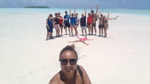 a group of people on a beach posing for the camera