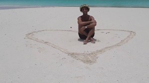 a person that is standing in the sand on a beach